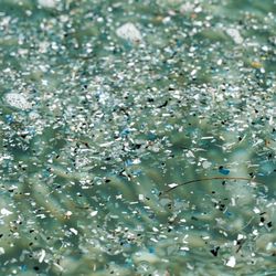 An underwater photo showing thousands of pieces of microplastics floating around in what looks like an unpleasant soup.