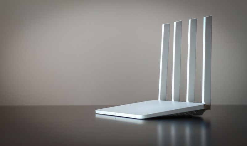 Wifi router standing on a clear table. 
