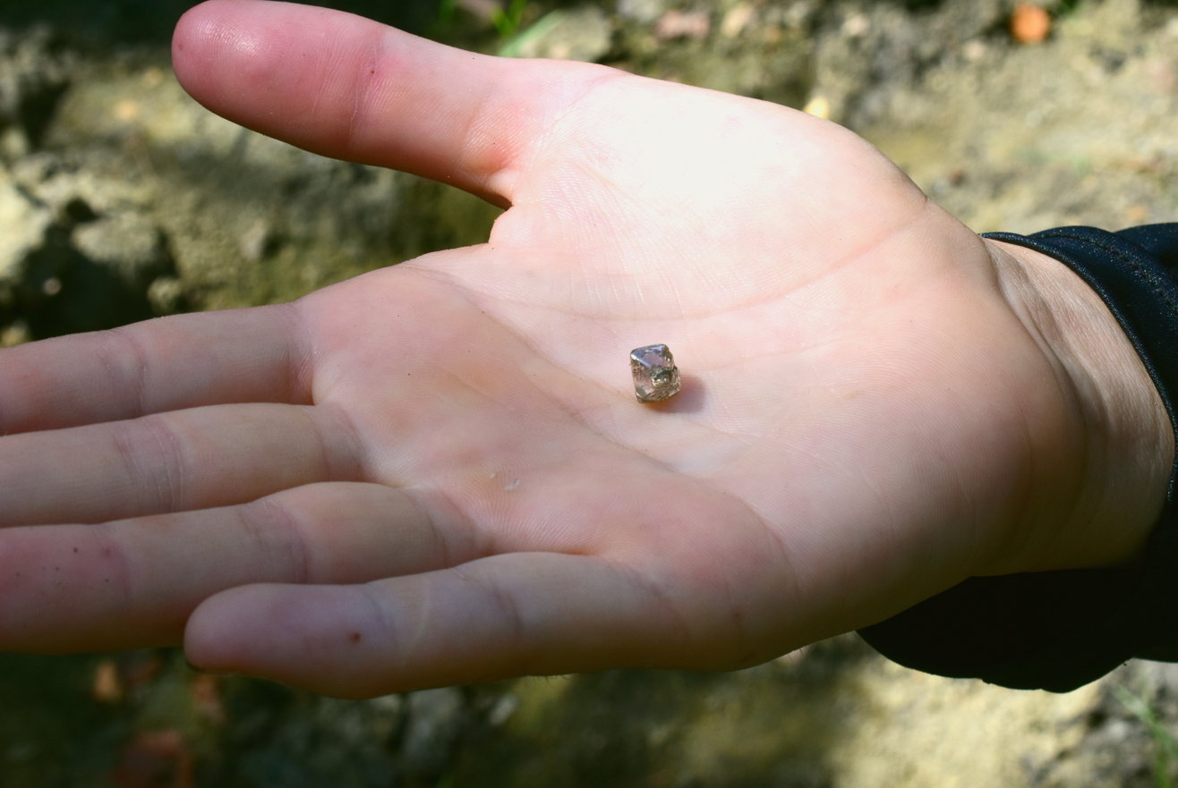 A 2.3 carat diamond in a woman's hand A 2.3 carat diamond in a woman's hand